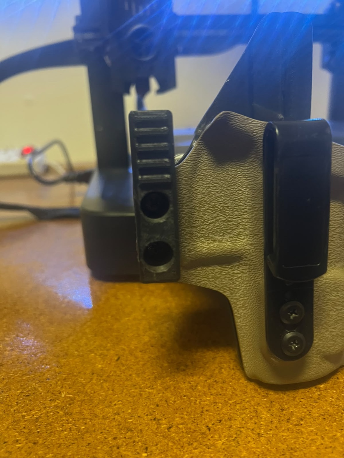Custom black 3D printed functional component fitted to a holster