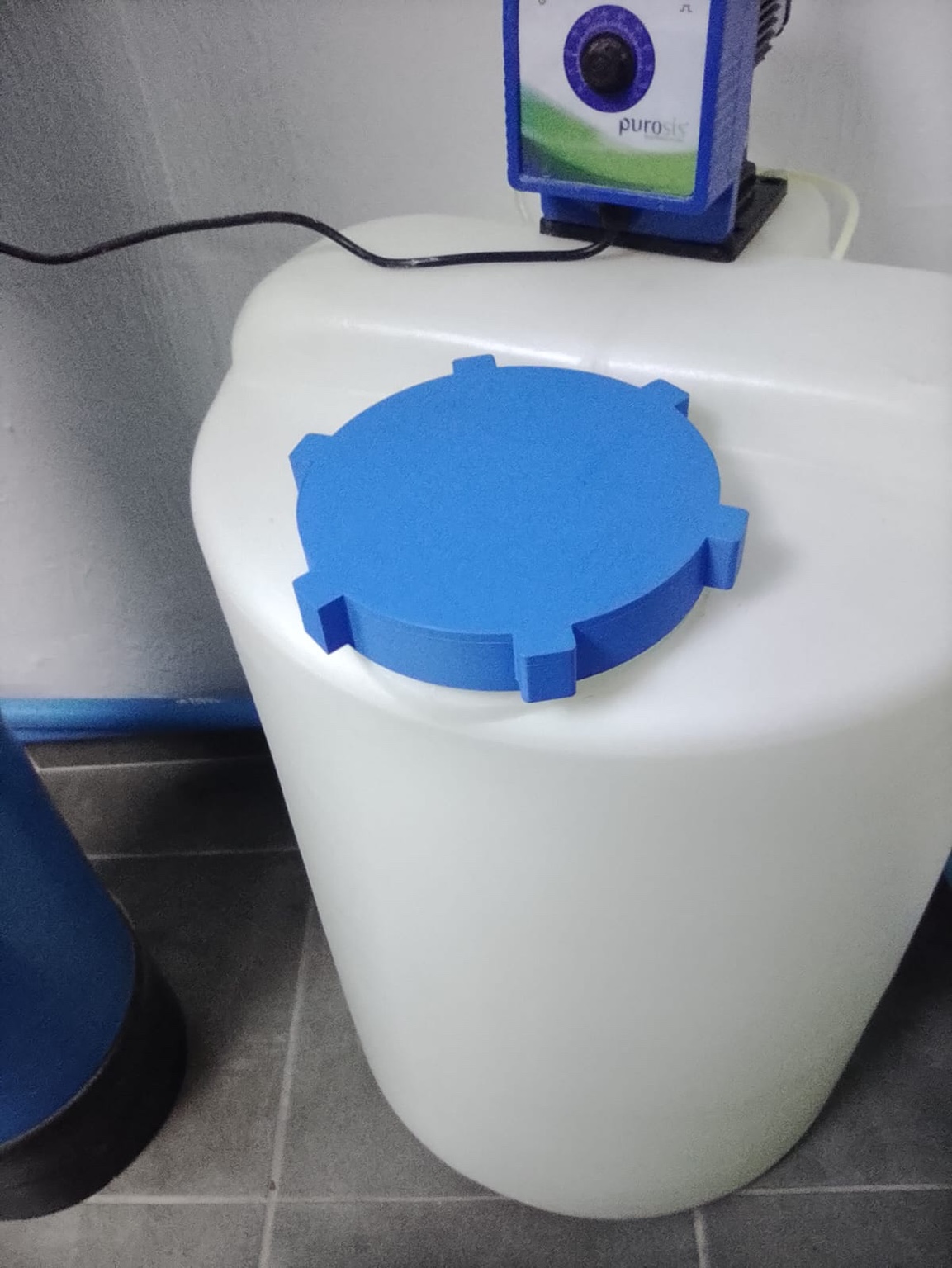 Blue 3D printed replacement lid fitted to a white water tank